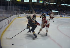 Charlottetown Islanders defenceman Jérémie Biakabutuka, 13, and Acadie-Bathurst Titan forward Thomas Belgarde, 18, pursue a loose puck during Game 2 of a Quebec Major Junior Hockey League playoff series between the teams at Eastlink Centre on May 16. The Islanders won the series 3-0, and open the best-of-five semifinal series against Sherbrooke in Charlottetown on May 25 at 7 p.m. Jason Simmonds • The Guardian