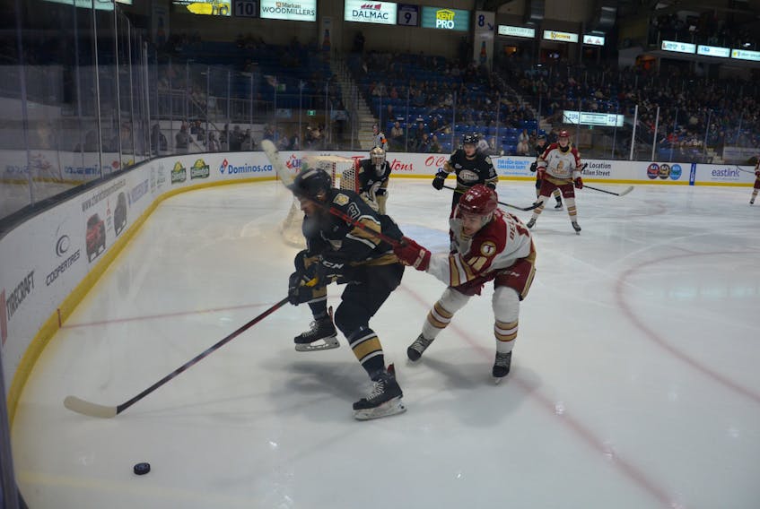 Charlottetown Islanders defenceman Jérémie Biakabutuka, 13, and Acadie-Bathurst Titan forward Thomas Belgarde, 18, pursue a loose puck during Game 2 of a Quebec Major Junior Hockey League playoff series between the teams at Eastlink Centre on May 16. The Islanders won the series 3-0, and open the best-of-five semifinal series against Sherbrooke in Charlottetown on May 25 at 7 p.m. Jason Simmonds • The Guardian