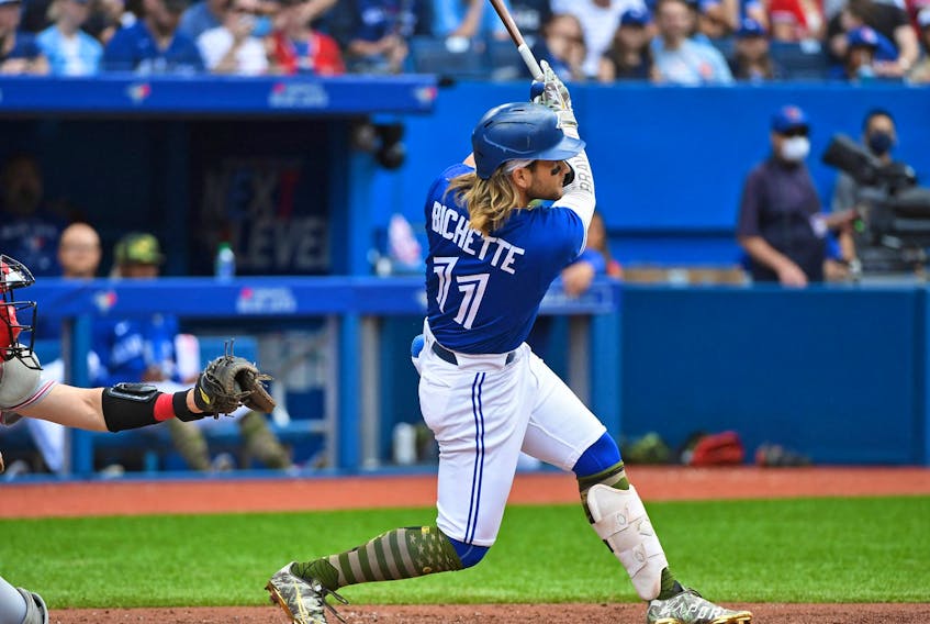 Toronto Blue Jays shortstop Bo Bichette (11) hits a solo home run in the fourth inning against the Cincinnati Reds at Rogers Centre.