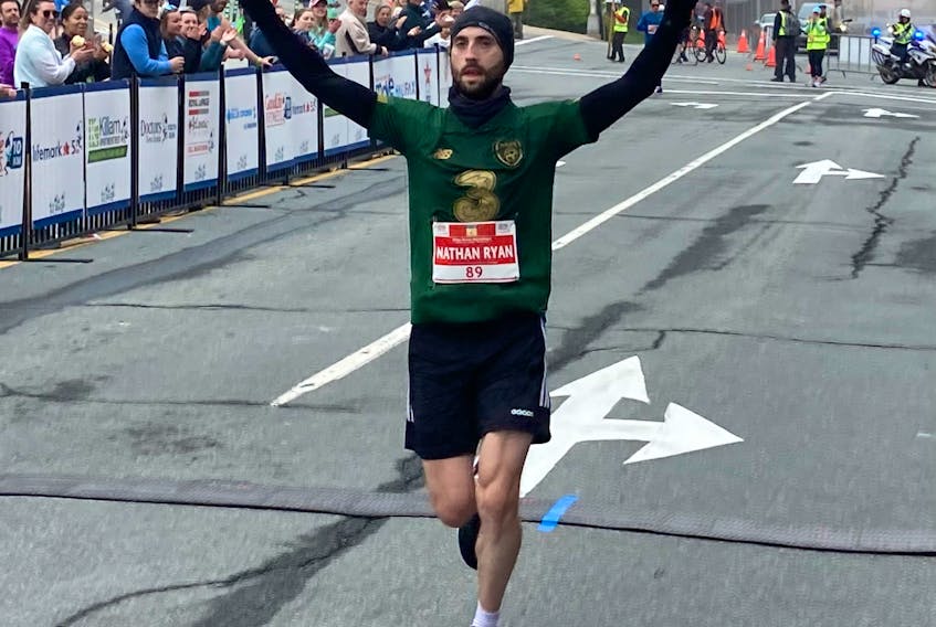 Nathan Ryan O Hehir, who's originally from Cork, Ireland, crosses the finish line first in the men's full marathon at the Blue Nose Marathon in Halifax on Sunday. He posted a personal-best time of 2:42:27. - GLENN MacDONALD / THE CHRONICLE HERALD