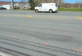 Fred MacIntyre says he started noticing some red dashed markings surrounding several potholes and ruts on the Sydney-Glace Bay highway — “the kids around here make fun of them, calling it ‘hopscotching the Grand Lake Road,’" he says. IAN NATHANSON/CAPE BRETON POST