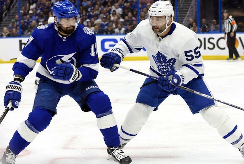 May 6, 2022; Tampa, Florida, USA; Toronto Maple Leafs defenseman Mark Giordano (55) and Tampa Bay Lightning left wing Alex Killorn (17) fight to control the puck during the first period of game three of the first round of the 2022 Stanley Cup Playoffs against the Tampa Bay Lightning at Amalie Arena.  