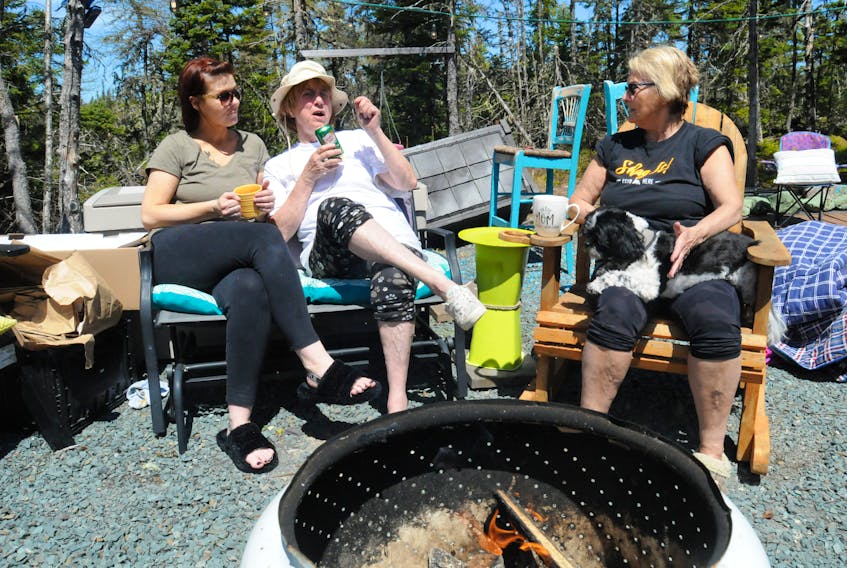 St. John’s residents and campsite neighbours (from left) Rachel Hoyles, Freda Chaulk and Liz Jackson (Rachel’s mom), with her dog Georgia, enjoy an afternoon beverage break and chat at Rachel and Liz’s site at the Gushue’s Pond Park campground in Brigus Junction on Saturday afternoon, May 21. Joe Gibbons • The Telegram