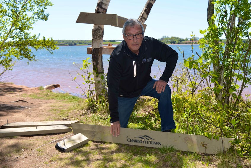 Coun. Kevin Ramsay shows a city bench that was broken apart this past weekend and set on fire in a wooded area just off Queen Elizabeth Park in Charlottetown. Dave Stewart • The Guardian