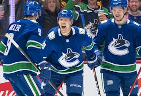 Alex Chiasson #39 of the Vancouver Canucks celebrates with teammates J.T. Miller #9 and Vasily Podkolzin #92 after scoring a goal against the Phoenix Coyotes during the first period at Rogers Arena on April 14, 2022 in Vancouver.