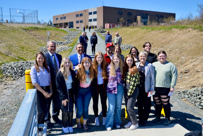 Members of Glace Bay High School’s Changemakers club gather with project advisors, politicians  and school staff to celebrate the official unveiling of The Burr project that includes a new pathway linking the post-secondary institution to a nearby shopping plaza. The student-led venture is being applauded for its initiative and contribution to the community. The top row of the group posing includes, from left, Glace Bay High School principal Donnie Holland, Cape Breton-Canso MP Mike Kelloway, student Steven MacKenzie, project advisors Marcie McKay and Stephanie Johnstone Laurette and student Daniel MacGillivary. The bottom row, from left, includes Nova Scotia Education Minister Becky Druhun, far left, and advisor Joyce Hooper, second from right. The six front row female students, in no particular order, are Rebcca MacMullin, Emily O’Neil, Claire McNeil, Brielyn Murrant, Makayla MacDonald and Samantha Catapano-MacDonald. DAVID JALA/CAPE BRETON POST
