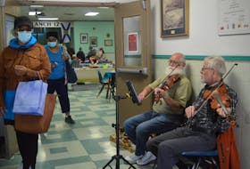 Royal Canadian Legion Branch 12 in Sydney was the scene for a craft fair opened for the benefit of visiting cruise ship passengers aboard the Zaandam on Wednesday. Greeting visitors at the door with some fiddle tunes were Carl Smith of Sydney, left, and Kevin McVarnish of South Bar. CAPE BRETON POST STAFF