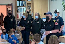 Members of the Barrington Port LaTour Fire Department visit one of the classrooms at Forest Ridge Academy in Barrington to give out smoke detectors to each of the students. KATHY JOHNSON