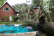 OTTAWA - May 23 2022 -  Hundreds of families from Navan were out clearing trees from their properties Monday after a storm ripped through the Ottawa area Saturday. Courtney Cameron assesses the damage of her property and house Monday in Navan.   TONY CALDWELL, Postmedia.