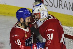 Rocket goalie Cayden Primeau and forward Danick Martel celebrate the team's Game 2 victory over the Rochester Americans at Place Bell in Laval on Monday.