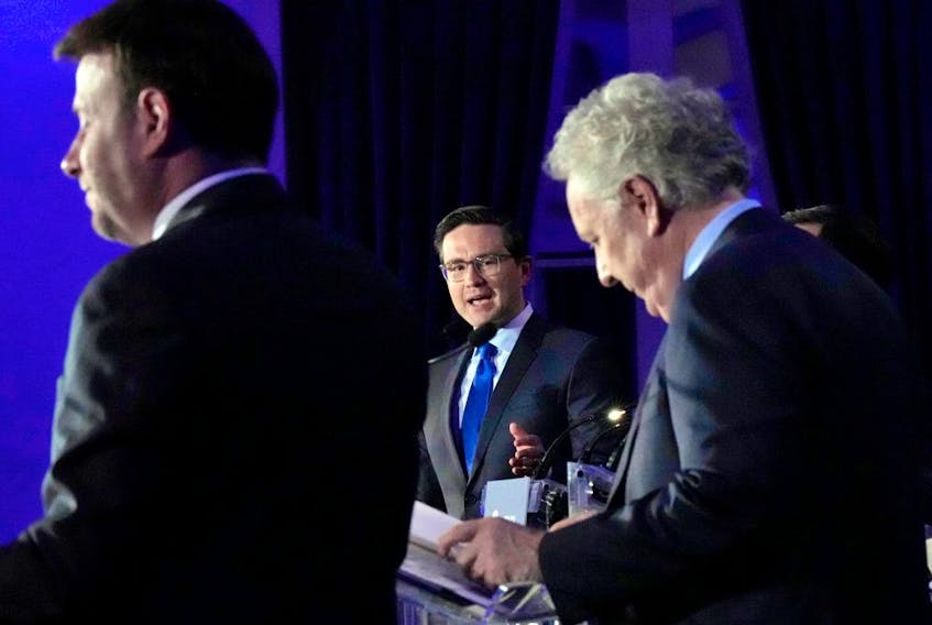 Candidates Roman Baber, left, Pierre Poilievre and Jean Charest, right, take part in the French language Conservative Leadership debate Wednesday, May 25, 2022  in Laval, Que.