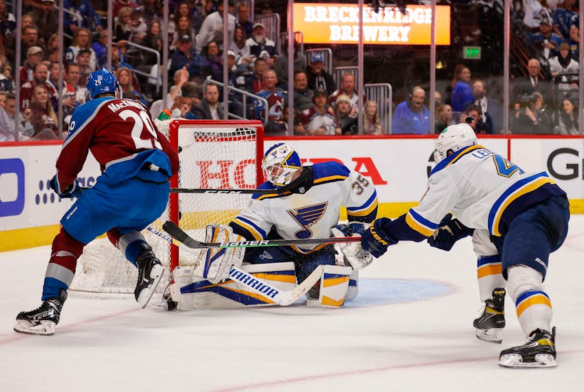 May 25, 2022; Denver, Colorado, USA; Colorado Avalanche center Nathan MacKinnon (29) scores a goal past St. Louis Blues goaltender Ville Husso (35) and defenseman Nick Leddy (4) defends in the third period in game five of the second round of the 2022 Stanley Cup Playoffs at Ball Arena. Mandatory Credit: Isaiah J. Downing-USA TODAY Sports  Colorado Avalanche centre Nathan MacKinnon (29) scores a highlight-reel goal against St. Louis Blues goaltender Ville Husso and defenceman Nick Leddy (4) in the third period of Game 5 of the second round of the 2022 Stanley Cup Playoffs at Ball Arena on Wednesday. - Isaiah J. Downing-USA TODAY Sports