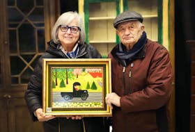 Irene and Tony Demas pose with their rare Maud Lewis painting which sold for $350,000 at an auction on May 14.
