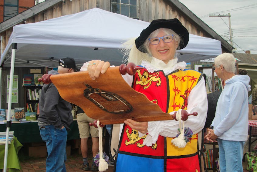 Christine Igot is the new town crier in Annapolis Royal.Town crier Christine Igot rings a large hand bell to attract everyone’s attention prior to her first cry at the Annapolis Royal Farmers and Traders Market on May 21.