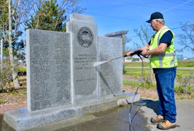 Former steelworker and current Nova Scotia Lands employee Steve Gillis uses a high-pressure washer to clean the moss off the memorial dedicated to workers who lost their lives at the Sydney steel plant. Gillis was joined at the memorial, located in Open Hearth Park on the site of the once massive operation, by another former steelworker, Gordie Buist. Buist's uncle Ernie Buist worked in the plant’s industrial relations division and turned 104 last week. DAVID JALA/CAPE BRETON POST