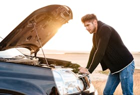 Young upset casual man trying to fix his broken car outdoors  Issues with a radiator can cause an engine to overheat and a driver’s frustration to boil over. Storyblocks photo