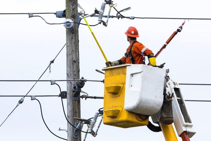 A Hydro Ottawa Hydro lineman finishes up repairs to a power line on Croydon Avenue in the city's west end on Thursday.