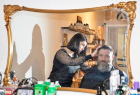 Stylist Chelsie Richards prepares to trim the beard of regular customer Jason Horton at the Cape Breton Beard Factory’s new location in the Joan Harris Cruise Pavilion in Sydney. The outlet, which also offers a line of shop-produced beard oils and other accessories, opened its doors earlier this month. DAVID JALA/CAPE BRETON POST