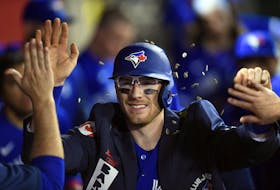 Danny Jansen  of the Toronto Blue Jays is showered with sunflower seeds in the dugout as he celebrate his solo home run against Los Angeles Angels during the ninth inning at Angel Stadium on May 26, 2022 in Anaheim.