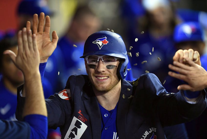 Danny Jansen  of the Toronto Blue Jays is showered with sunflower seeds in the dugout as he celebrate his solo home run against Los Angeles Angels during the ninth inning at Angel Stadium on May 26, 2022 in Anaheim.