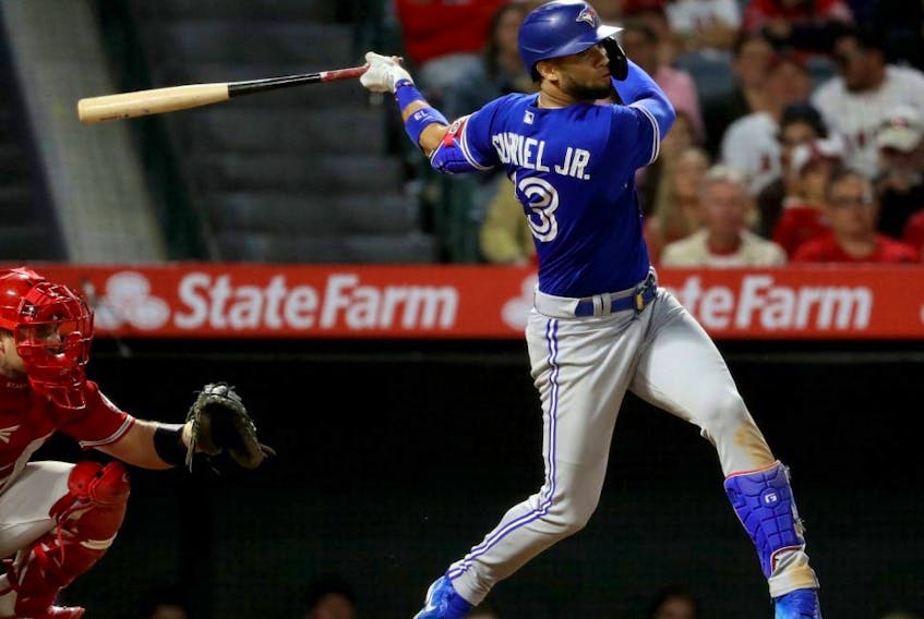 Blue Jays left fielder Lourdes Gurriel Jr. (13) hits an RBI single in the ninth inning against the Angels at Angel Stadium in Anaheim, Calif., Friday, May 27, 2022.