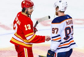 Calgary Flames forward Johnny Gaudreau (left) and Edmonton Oilers forward Connor McDavid shake hands after Game 5 of the second round of the 2022 Stanley Cup Playoffs at Scotiabank Saddledome. 
