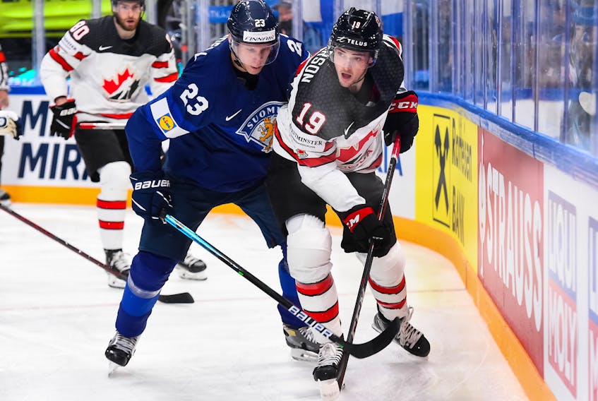 Canada's Drake Batherson (19) plays the along the boards against Finland's Esa Lindell during action in the championship game at the IIHF world hockey championships in Helsinki, Finland. - IIHF
