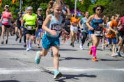 Runners, including Grace Clarke, take off from the start line of the 2K race at Tamarack Ottawa Race Weekend on Saturday.