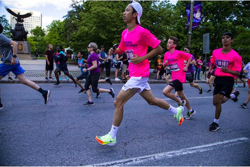 Ashbury College had a large team of runners in hot pink shirts in the 5K race on Saturday.