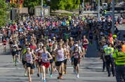 The first group of runners runs up Elgin Street after turning off of Laurier Avenue during the 5K race on Saturday afternoon.
