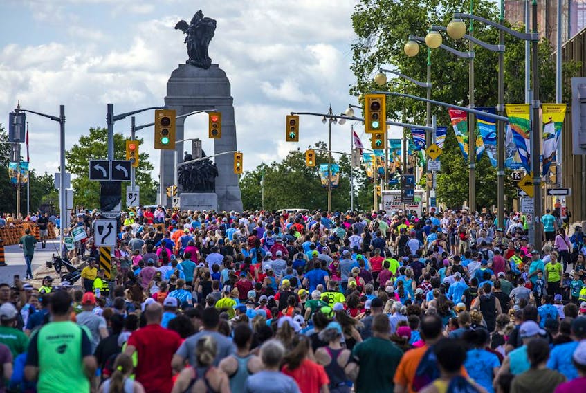 Runners make their way up the hill on Elgin Street, heading north towards the National War Memorial, during the 5K race on Saturday.