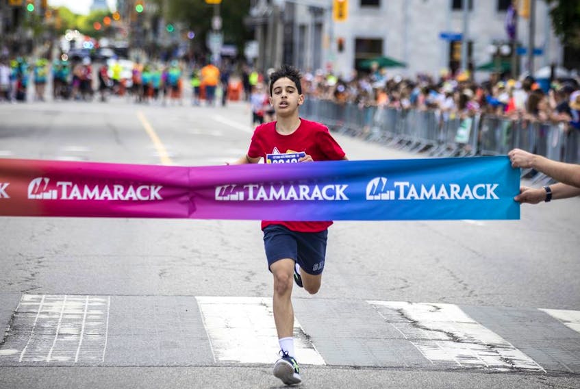 Mohamed Elhage was the first person across the finish line in the Kids Marathon on Saturday.