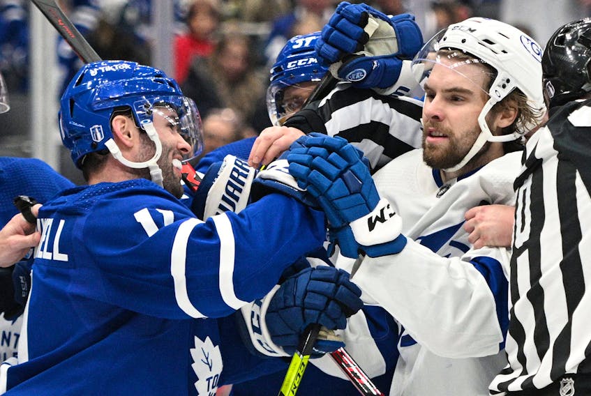 Toronto Maple Leafs forward Colin Blackwell (11) pushes Tampa Bay Lightning forward Nicholas Paul (20) in game one of the first round of the 2022 Stanley Cup Playoffs at Scotiabank Arena
