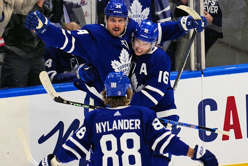 Maple Leafs' Mitchell Marner and William Nylander congratulate Auston Matthews on his goal against the Tampa Bay Lightning during the second period in Game 1 of their first-round Stanley Cup playoff series at Scotiabank Arena on Monday, May 2, 2022. 