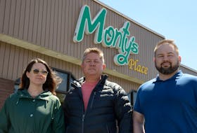 Bridget Lynch, Monty Petipas (centre) and his son, Peter, stand in front of the now-closed restaurant Monty’s Place in Whitbourne Tuesday, May 3. Keith Gosse • The Telegram