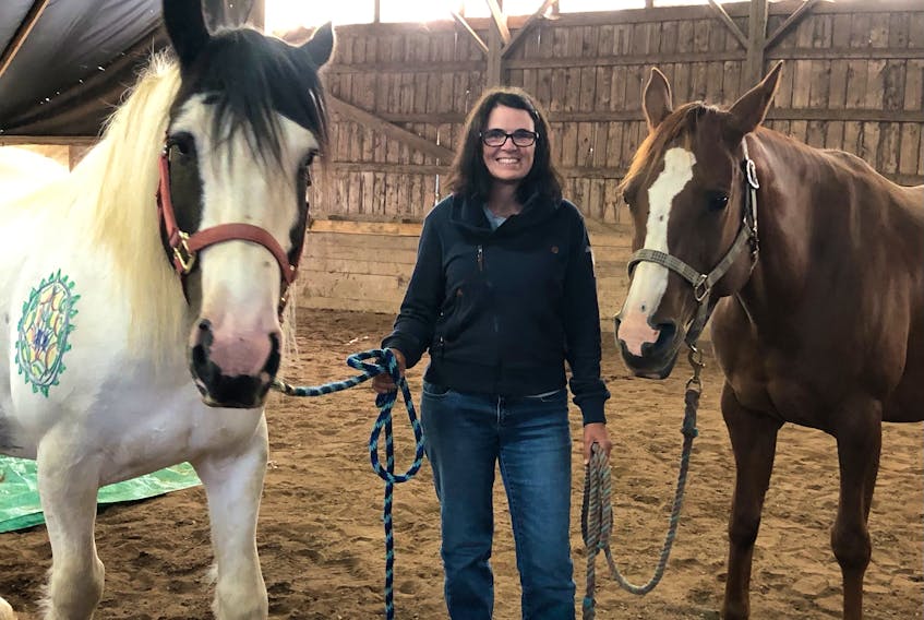 Flanked by Tinker and Annie, Jennifer Kirk offers several specialized equine facilitated learning workshop for nurses each year.
