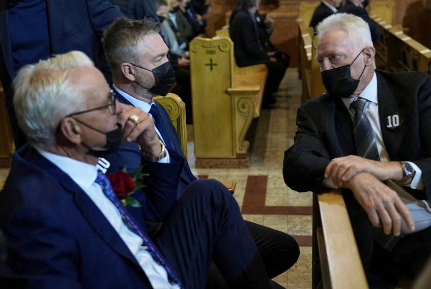 Former Montreal Canadiens, from left, Mario Tremblay, Patrick Roy and Larry Robinson attend the funeral services for Canadiens legend Guy Lafleur at Mary, Queen of the World Cathedral in Montreal on May 3, 2022.