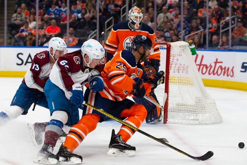 Darnell Nurse #25 of the Edmonton Oilers battles against Artturi Lehkonen #62 of the Colorado Avalanche during the first period at Rogers Place on April 22, 2022.
