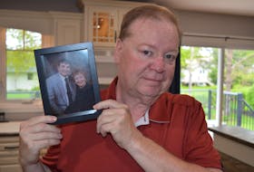 Michael James of Charlottetown holds a picture of his parents, Harry, left, and Donna, following an interview with the SaltWire Network on May 30. Harry James of Stratford died on May 26. Dave Stewart • The Guardian