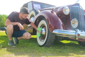 Logan Morse shines up his grandfather Robert Morse’s 1937 Packard Super 8 convertible. Logan and his father Robert were at the Apple Blossom car show at the Coldbrook Lions Club on May 29.