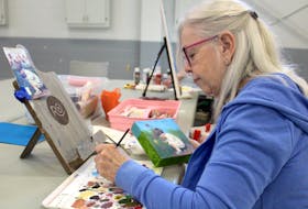 Diane Lawrence works on a painting during the Glace Bay Art Group’s weekly meeting at the Glace Bay fire hall on May 25. Although she describes herself as a “slow painter,” Lawrence drew inspiration from the COVID-19 pandemic. “I said to myself ‘Why don't I just do 19 paintings and call it my COVID-19 series?’” Chris Connors/Cape Breton Post