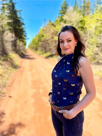 Maggie Shand of Hunter River, Prince Edward Island recently became an impromptu social media ambassador for the red dirt roads that wind through the countryside province-wide.  Shand has recently created a Facebook page called Dirt Road Adventures of P.E.I., which includes photos of the many enchanting hidden gems she has experienced.  Shand is seen here standing on Stanhope Lane. Sharon Hume photo
