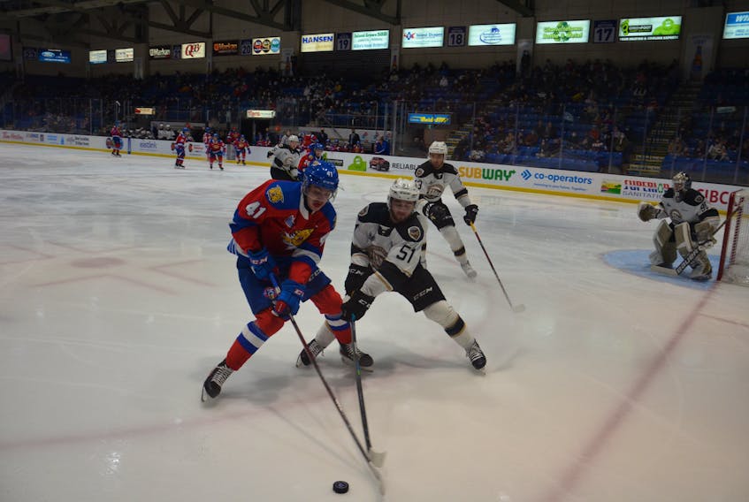 Charlottetown Islanders defenceman Lukas Cormier, 51, and Moncton Wildcats forward Manix Sarrasin, 41, battle for possession of the puck during a regular-season game between the two Quebec Major Junior Hockey League teams in Charlottetown on March 20. The teams begin a best-of-five playoff series in Charlottetown on May 5.