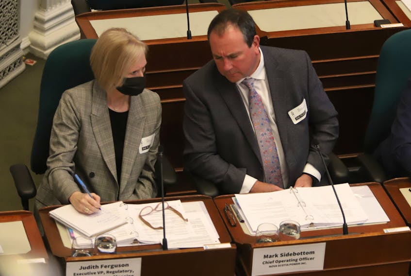 Mark Sidebottom, chief operating officer for Nova Scotia Power, speaks with Judith Ferguson, NSP's vice-president of planning, as he answers a question in front of the legislative committee on public accounts at Province House in Halifax on Wednesday May 4, 2022.

TIM KROCHAK PHOTO