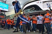 A member of the Oilers Drum and Brass Crew leaps into the air performing for fans at the tailgate party in the ICE district Plaza prior to the start of the Oilers game two against the LA Kings in Edmonton, May 4, 2022.