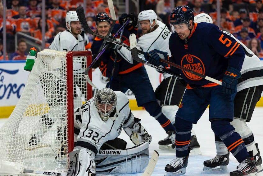 Edmonton Oilers' Cody Ceci (5) battles for position in front of L.A. Kings' goaltender Jonathan Quick (32) during first period NHL action in Game 2 of their first round Stanley Cup playoff series in Edmonton, on Wednesday, May 4, 2022. 