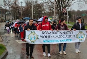 A group of about 50 people walked through downtown Sydney on Thursday afternoon to raise awareness about missing and murdered Indigenous women and girls on National Red Dress Day. Ardelle Reynolds/Cape Breton Post