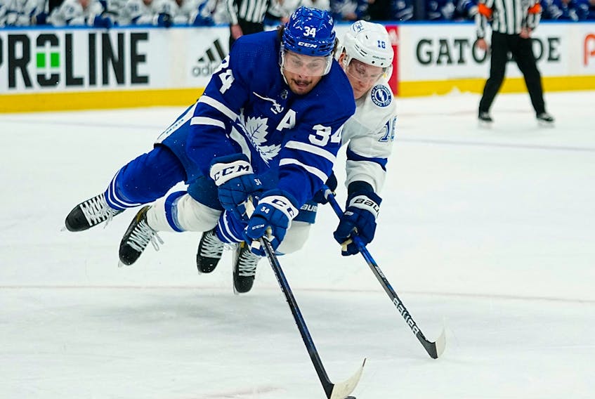 Toronto Maple Leafs forward Auston Matthews (34) battles with Tampa Bay Lightning forward Ondrej Palat (18) for the puck at Scotiabank Arena. 