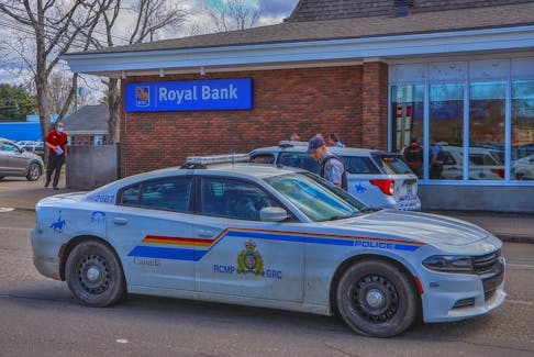 RCMP officers talk outside the Royal Bank in Berwick Thursday afternoon after a robbery at the branch.