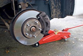 Closeup detail of the wheel assembly on a modern automobile.  The rim is removed showing the front rotor and caliper.  The first general rule of thumb is to check a vehicle’s owner’s manual to see if it identifies proper jacking points. Storyblocks photo